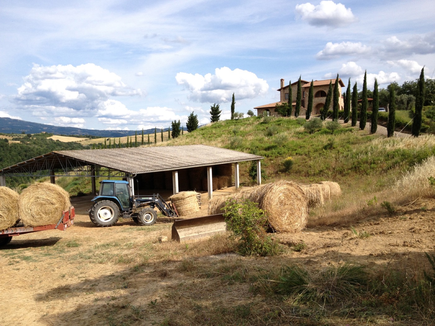 The agricultural warehouse with the casale on the hill behind it