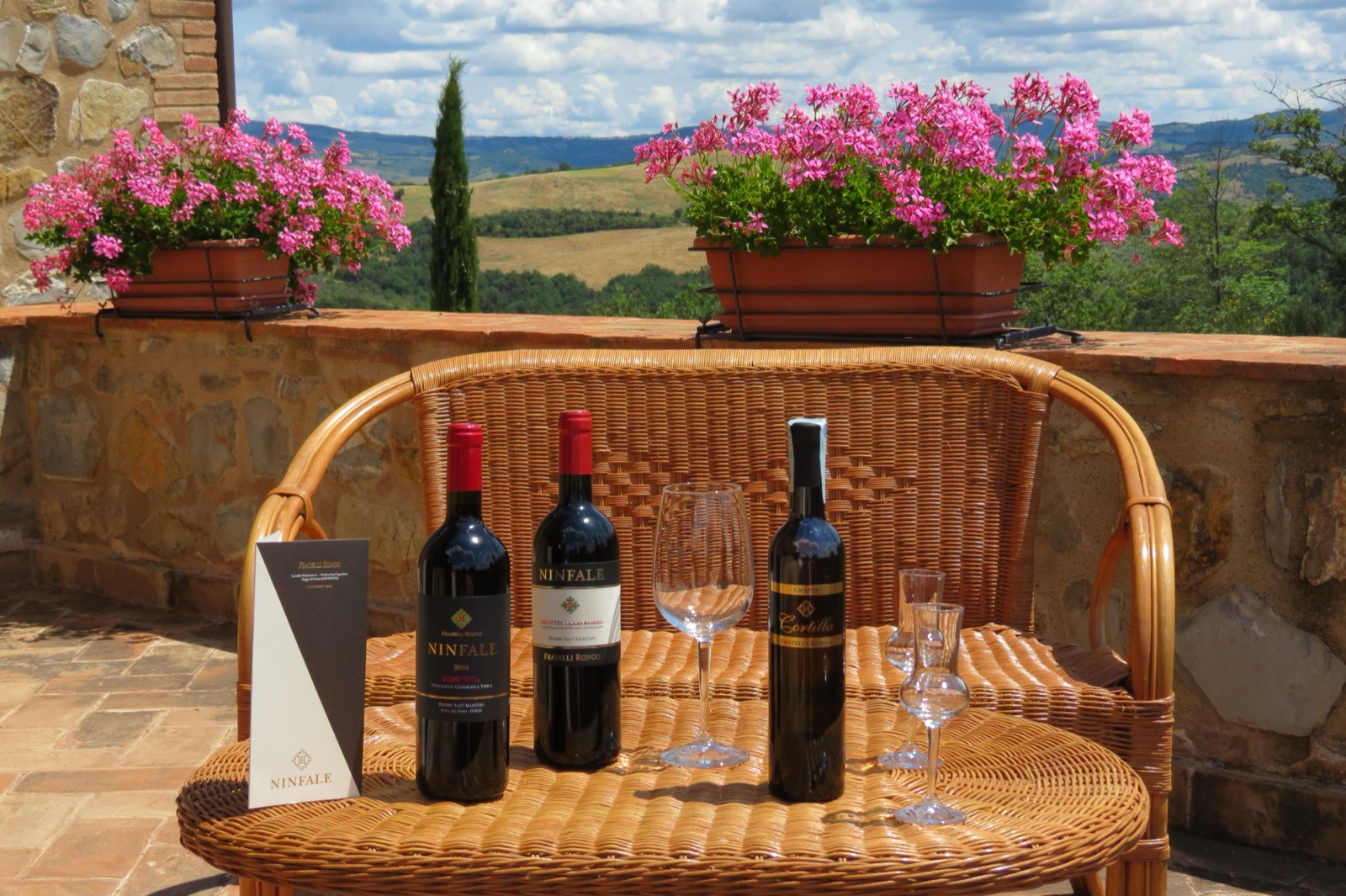 The Ninfale and Cortilla labels on the terrace, above the Montecucco hills